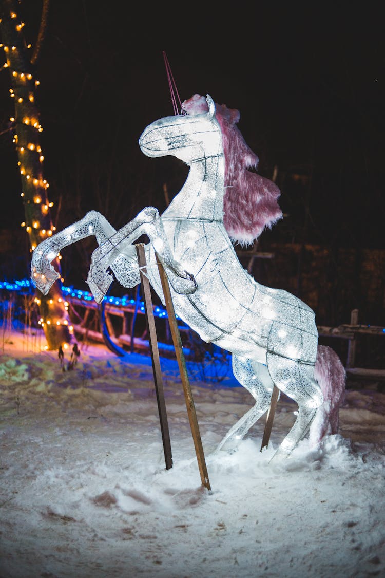 Unicorn Statue On Snow During Night Time