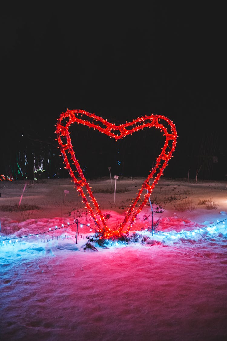 Decorative Heart And Glowing Garland On Snow On Valentines Day