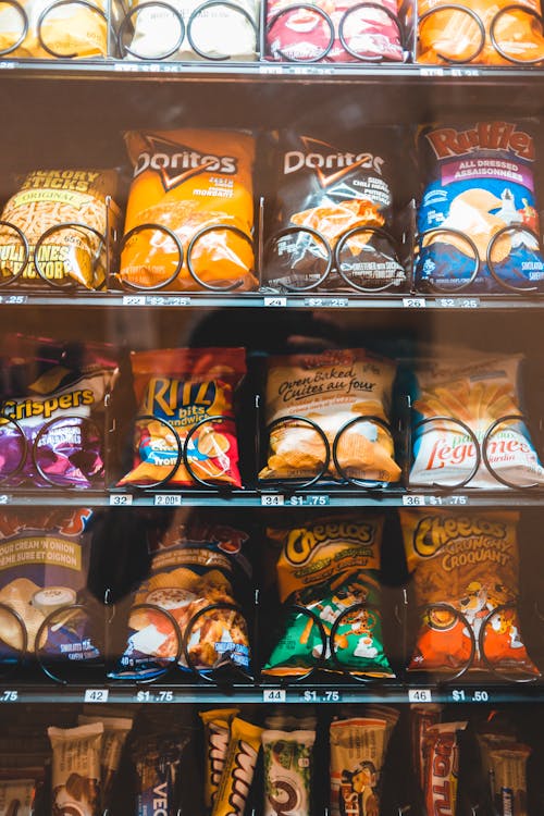 Shelves with assorted bright snack packages in machine