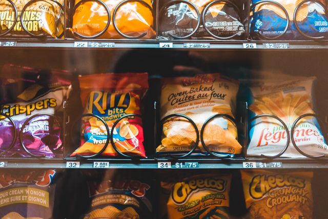 Fully stocked vending machine shelves of chips and snacks