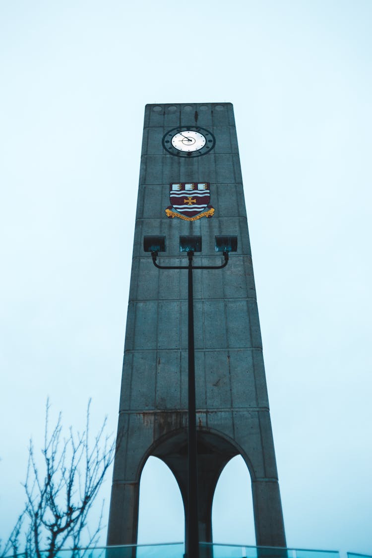 Modern Clock Tower Under Blue Sky In City