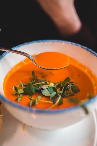 Vegetable tomato soup garnished with watercress