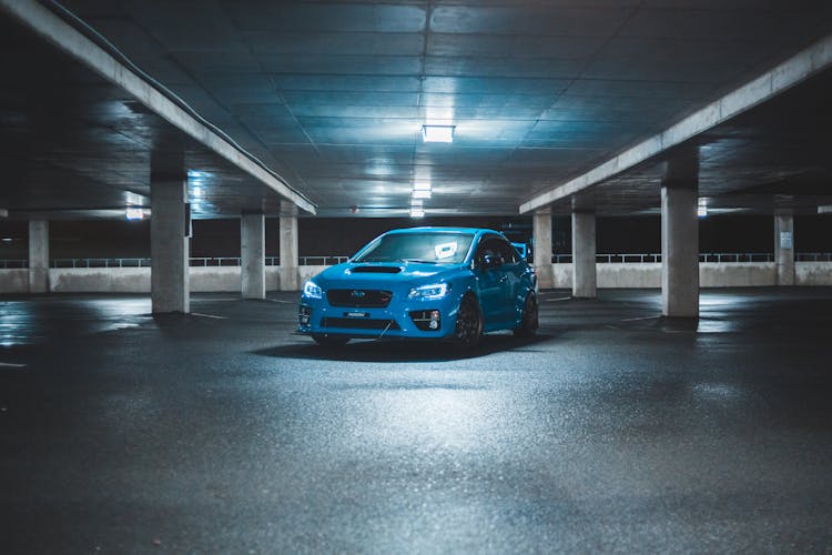 Modern Sport Car On Underground Parking At Night