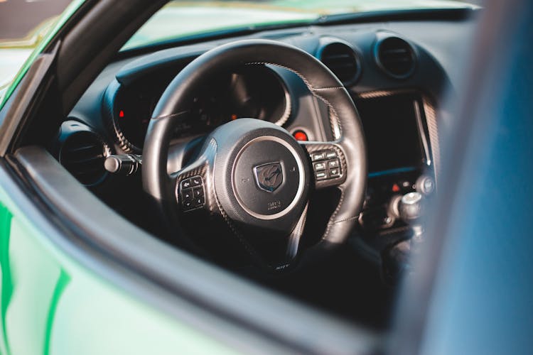 Modern Car Interior With Shiny Steering Wheel In Daylight