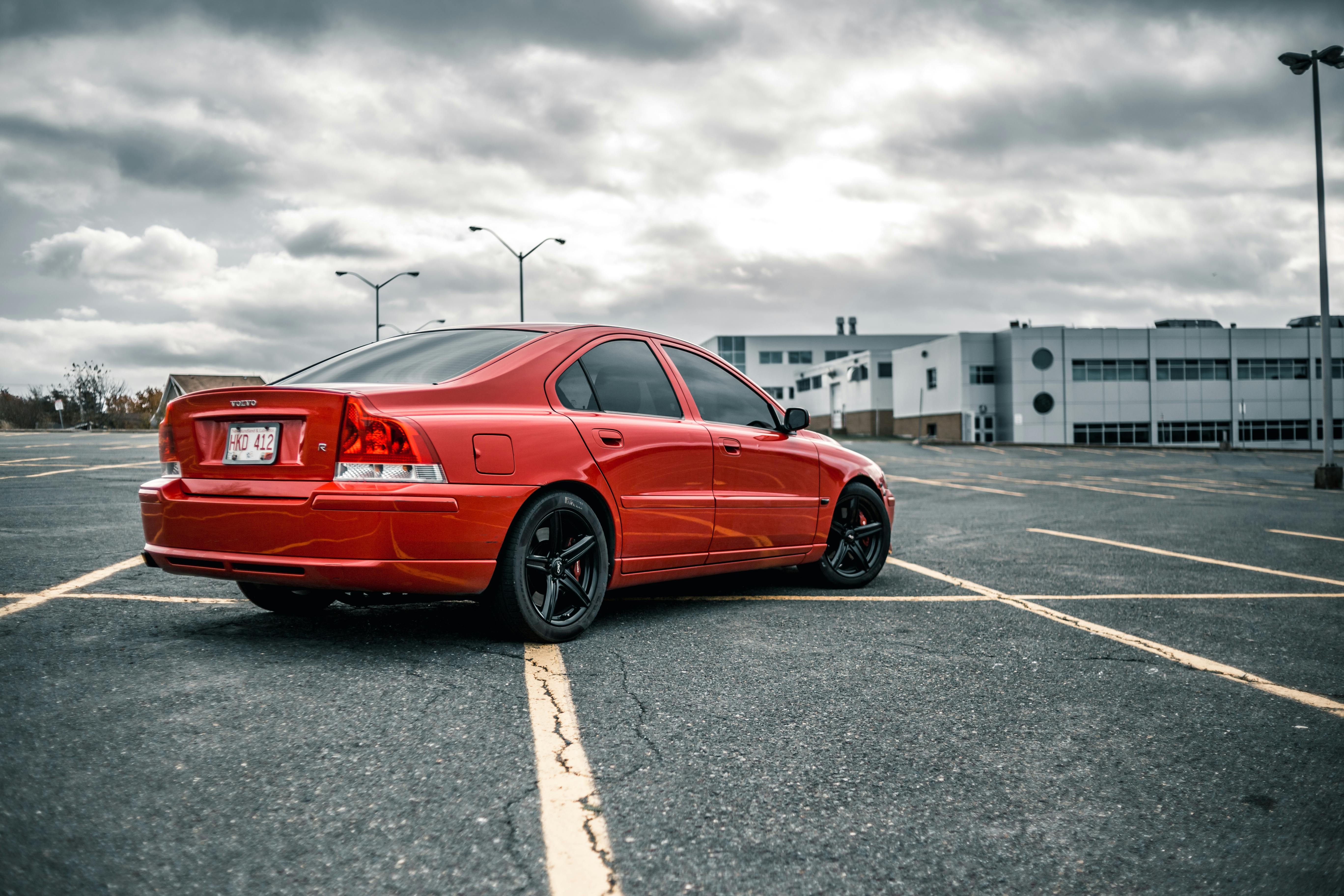 Red Volvo parked in the parking lot. | Photo: Pexels
