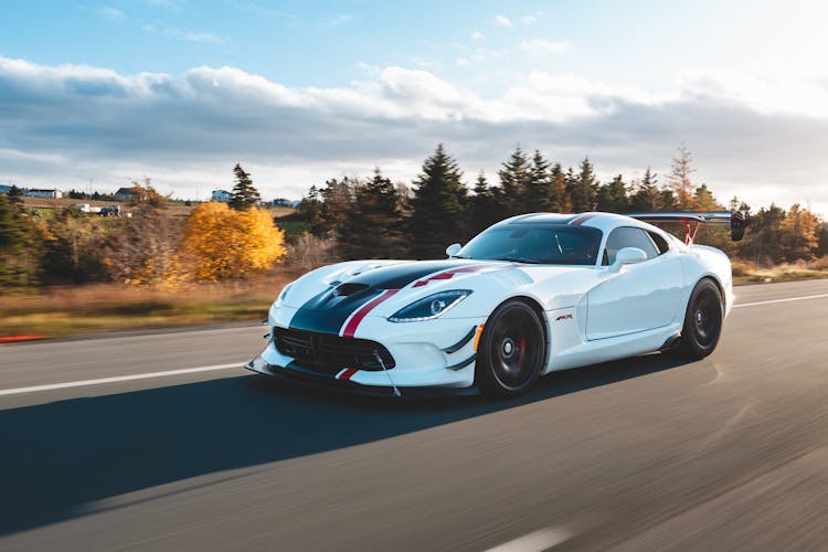 New Sport Car Driving On Road In Countryside In Autumn