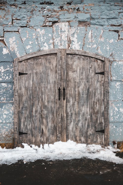 Brown Wooden Door on Snow Covered Ground