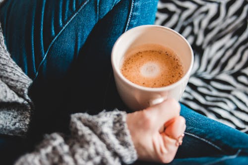 Person Holding White Ceramic Mug With Brown Liquid