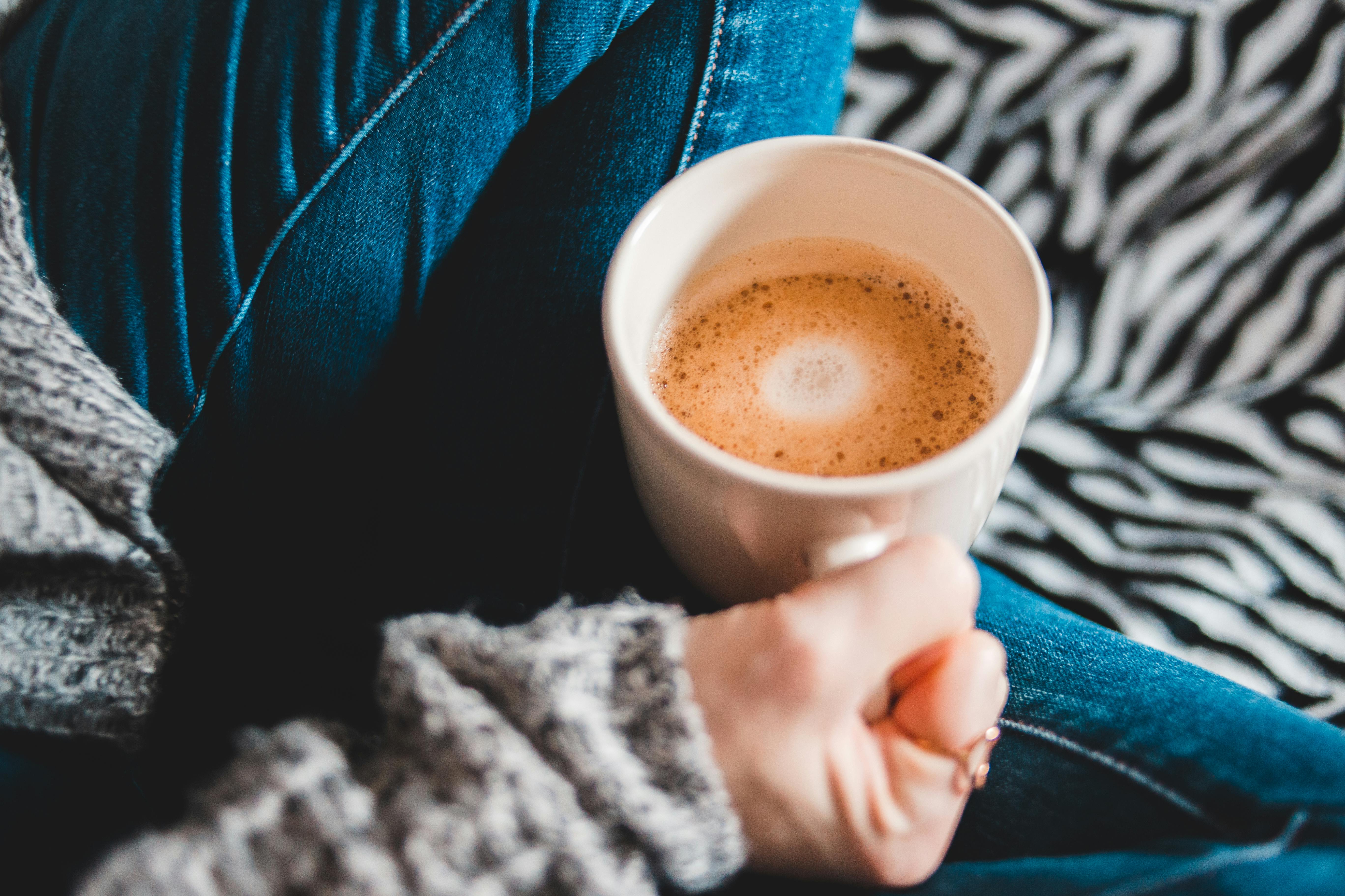 Person Holding White Ceramic Mug With Brown Liquid Free Stock Photo
