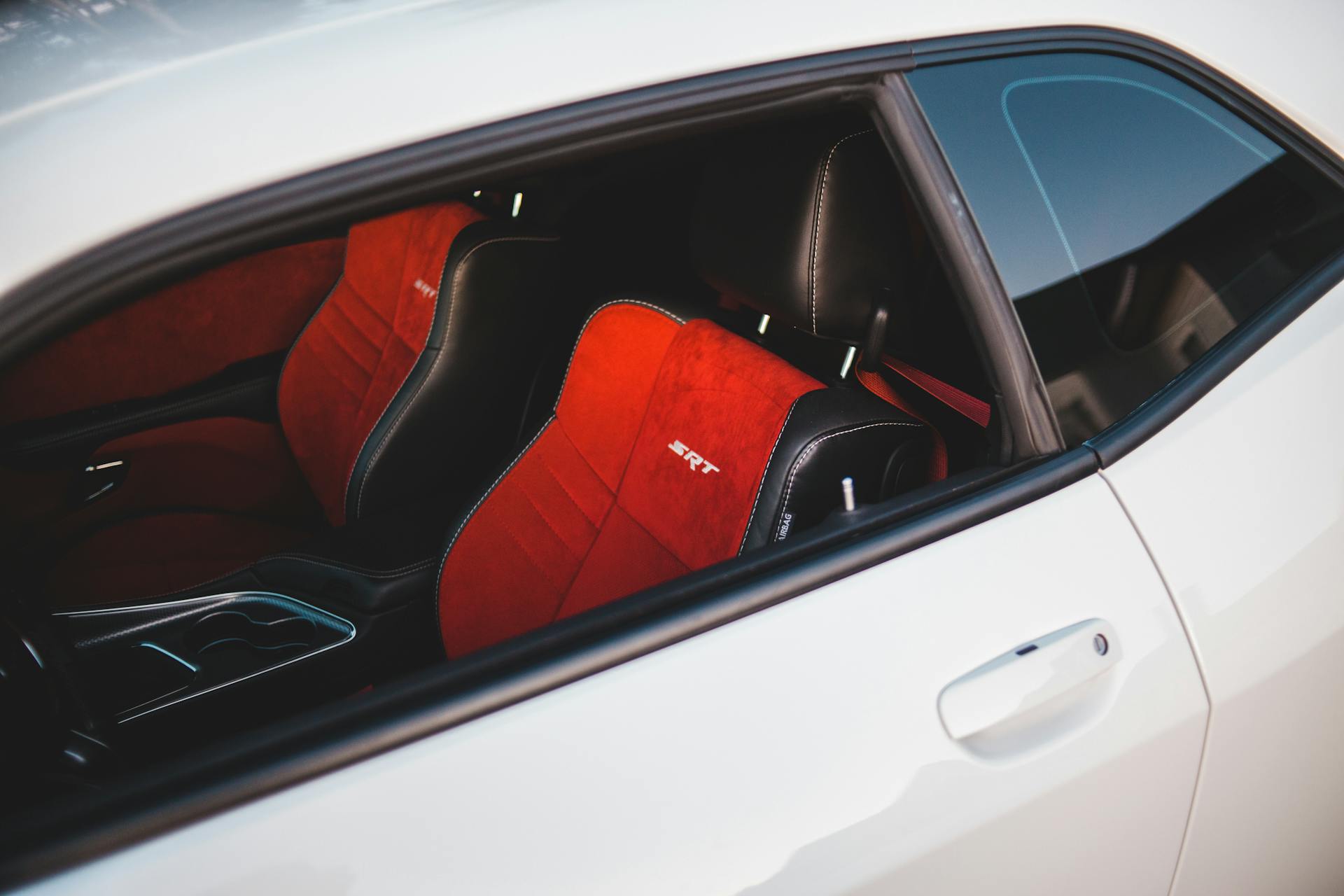 A luxury car showcasing a stylish red and black leather SRT interior.