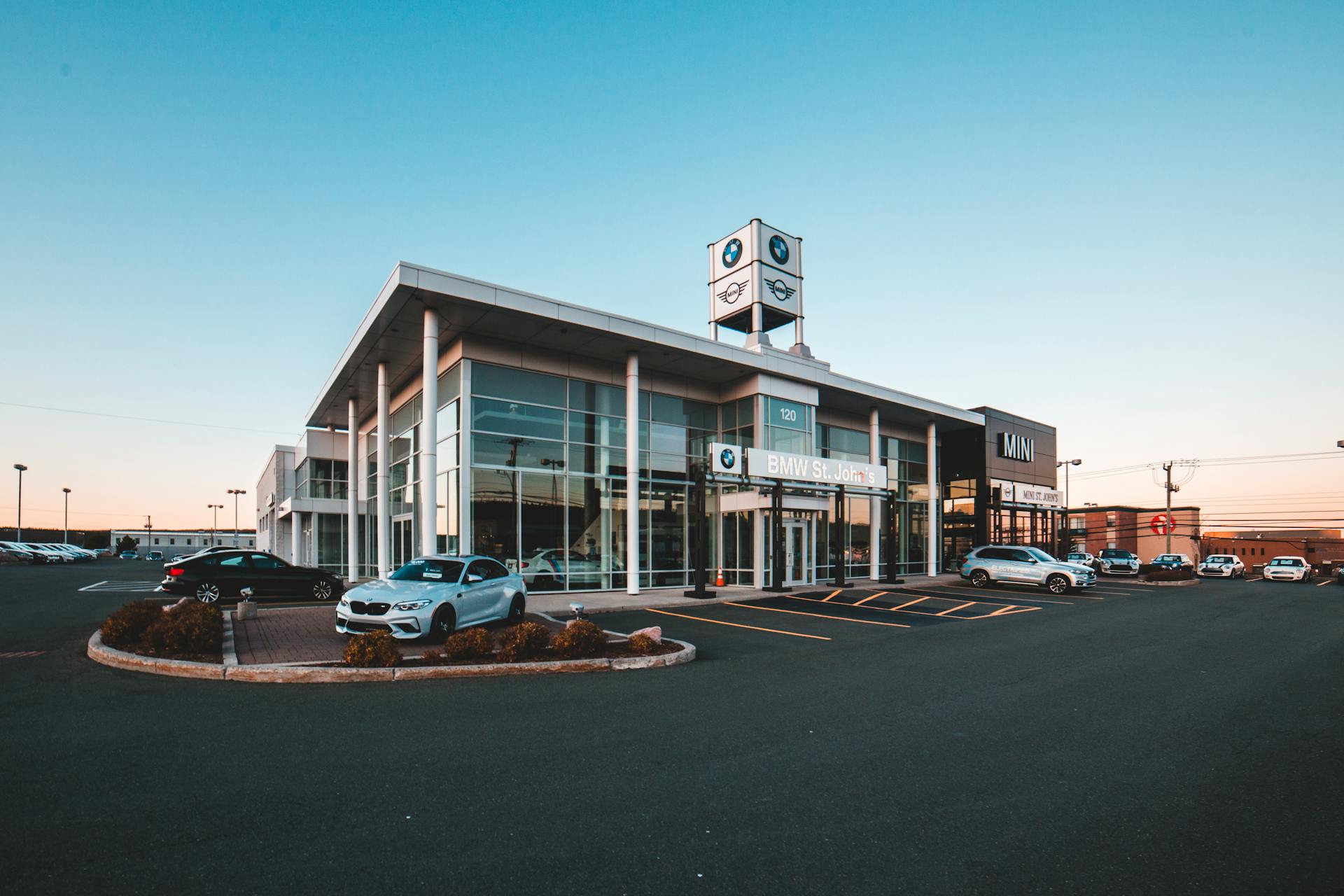 Cars Parked in Front of White and Blue Building