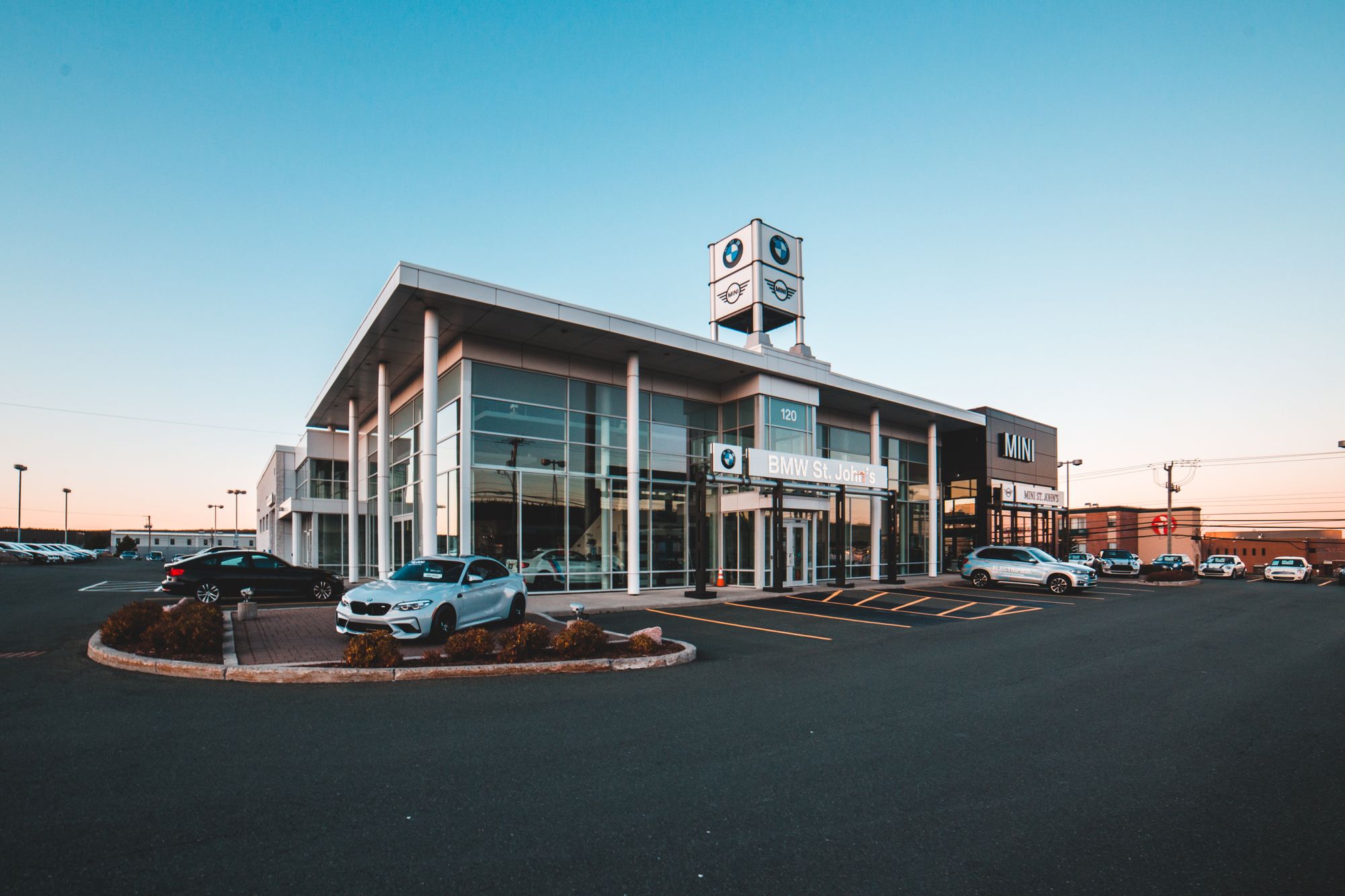 A BMW dealership exterior directly represents one of the three service tiers being compared in this section.