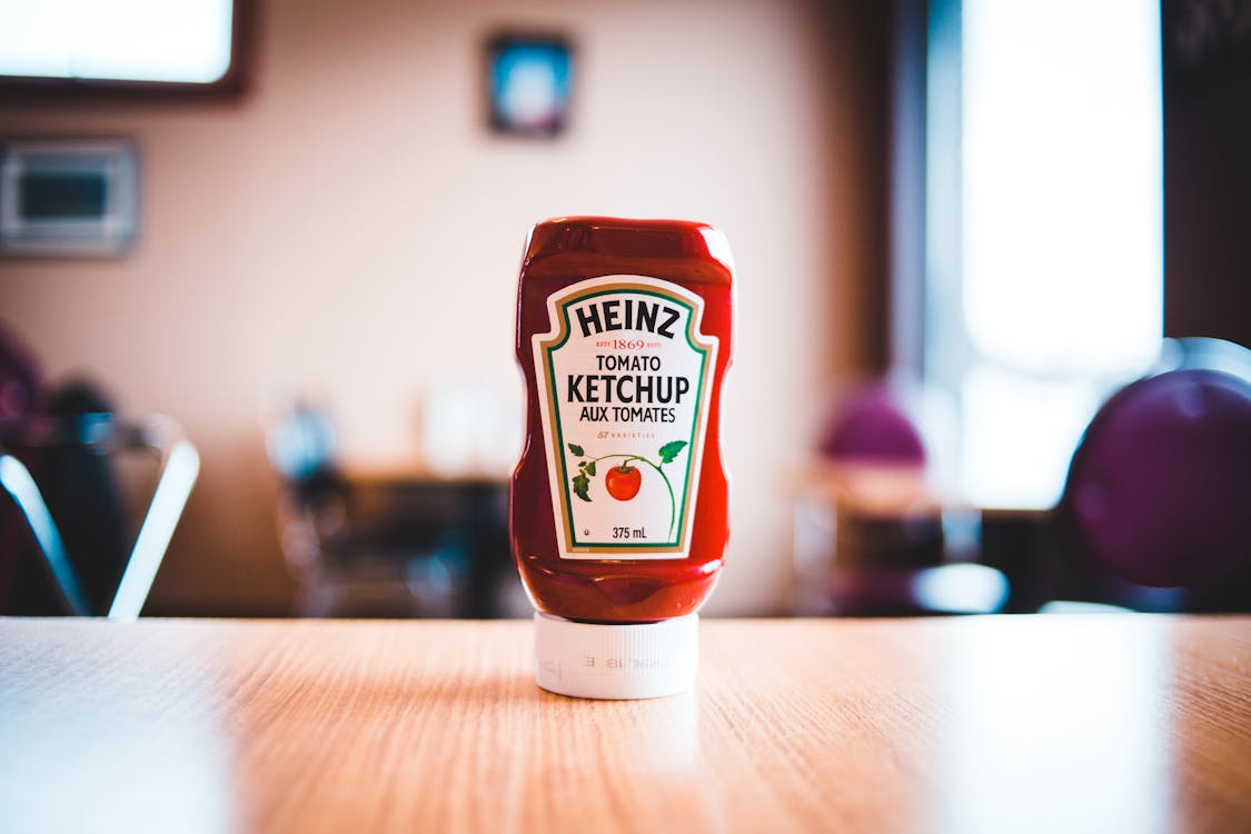 Free Heinz Tomato Ketchup Bottle on Brown Wooden Table Stock Photo