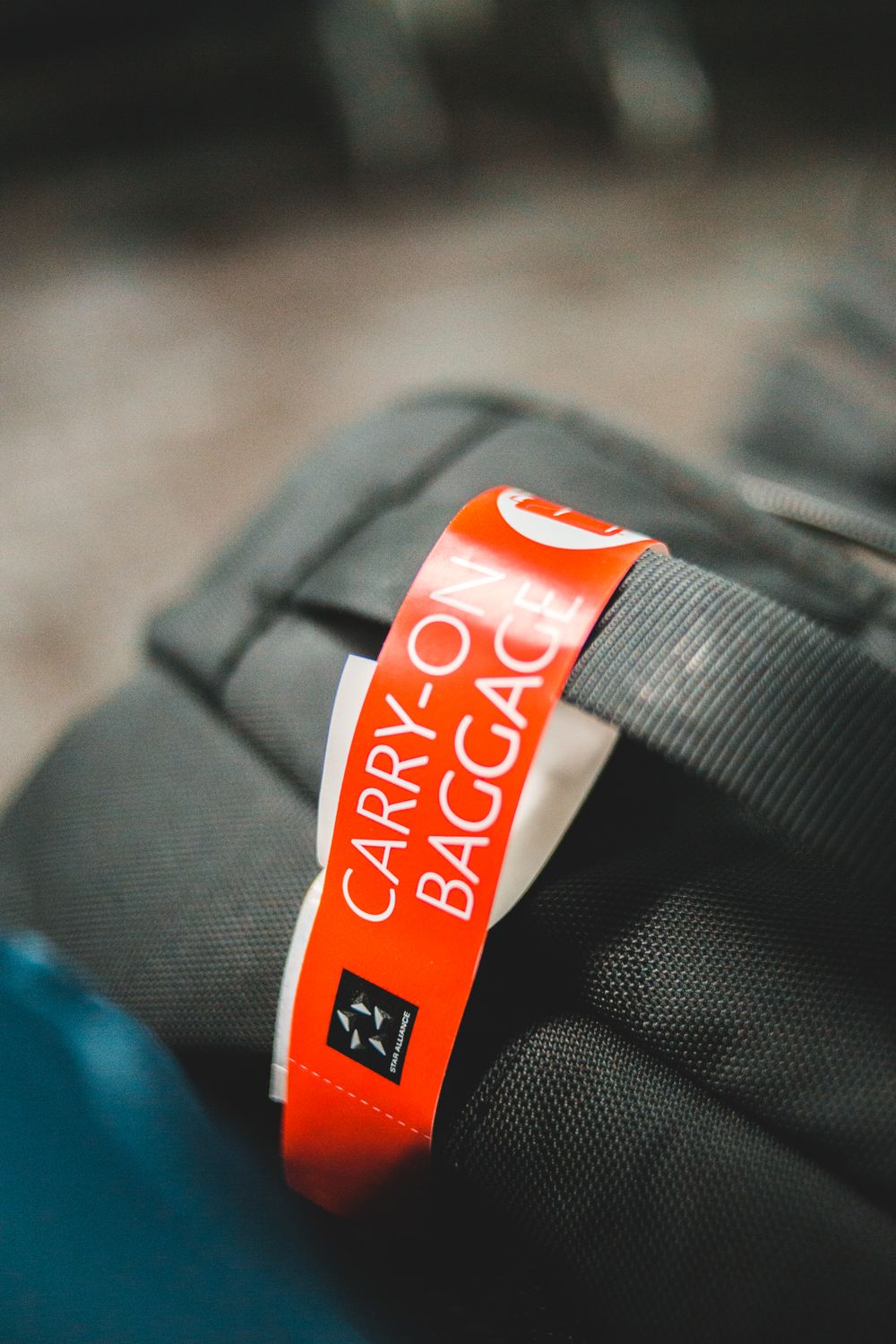 Close-up of a carry-on baggage tag attached to a travel bag