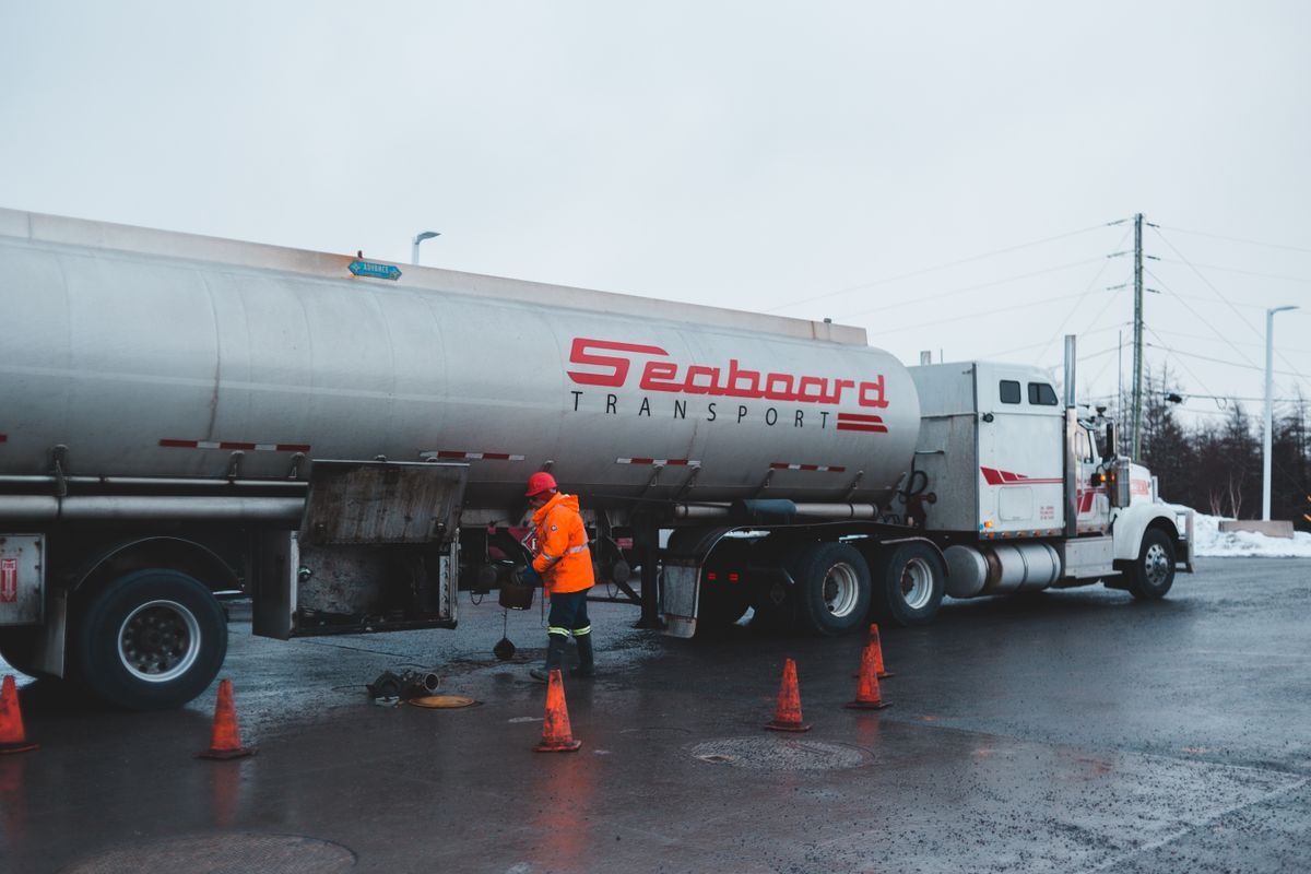 Driver performing a pre-trip tanker inspection