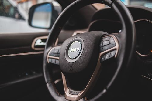 Free Detailed view of a Jeep steering wheel, showcasing luxury automotive interior design. Stock Photo