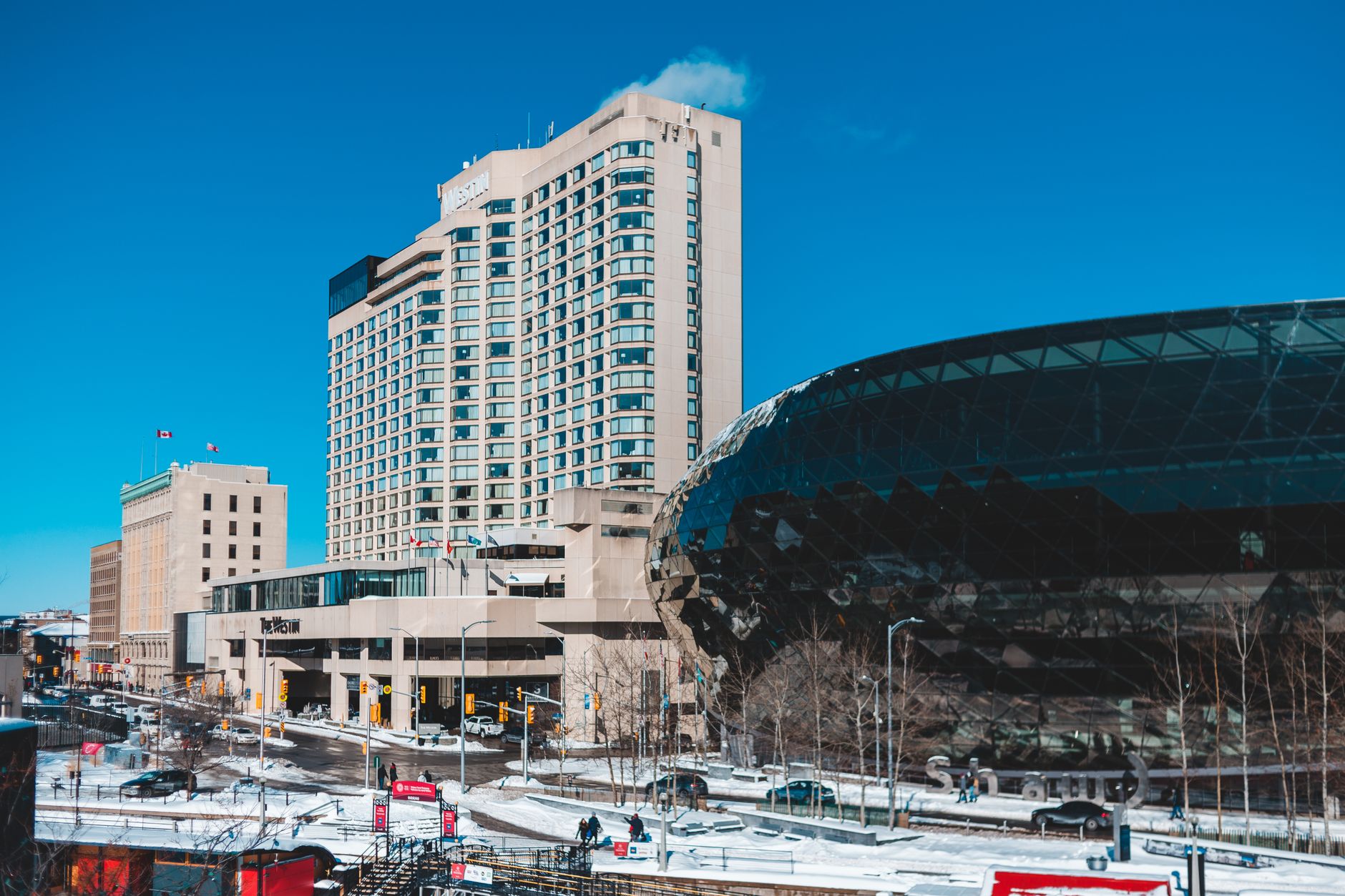 Cityscape featuring skyscrapers and modern architecture under a clear blue sky in winter.