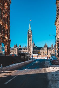 A scenic winter view of Parliament Hill with the iconic Peace Tower in Ottawa, Canada.