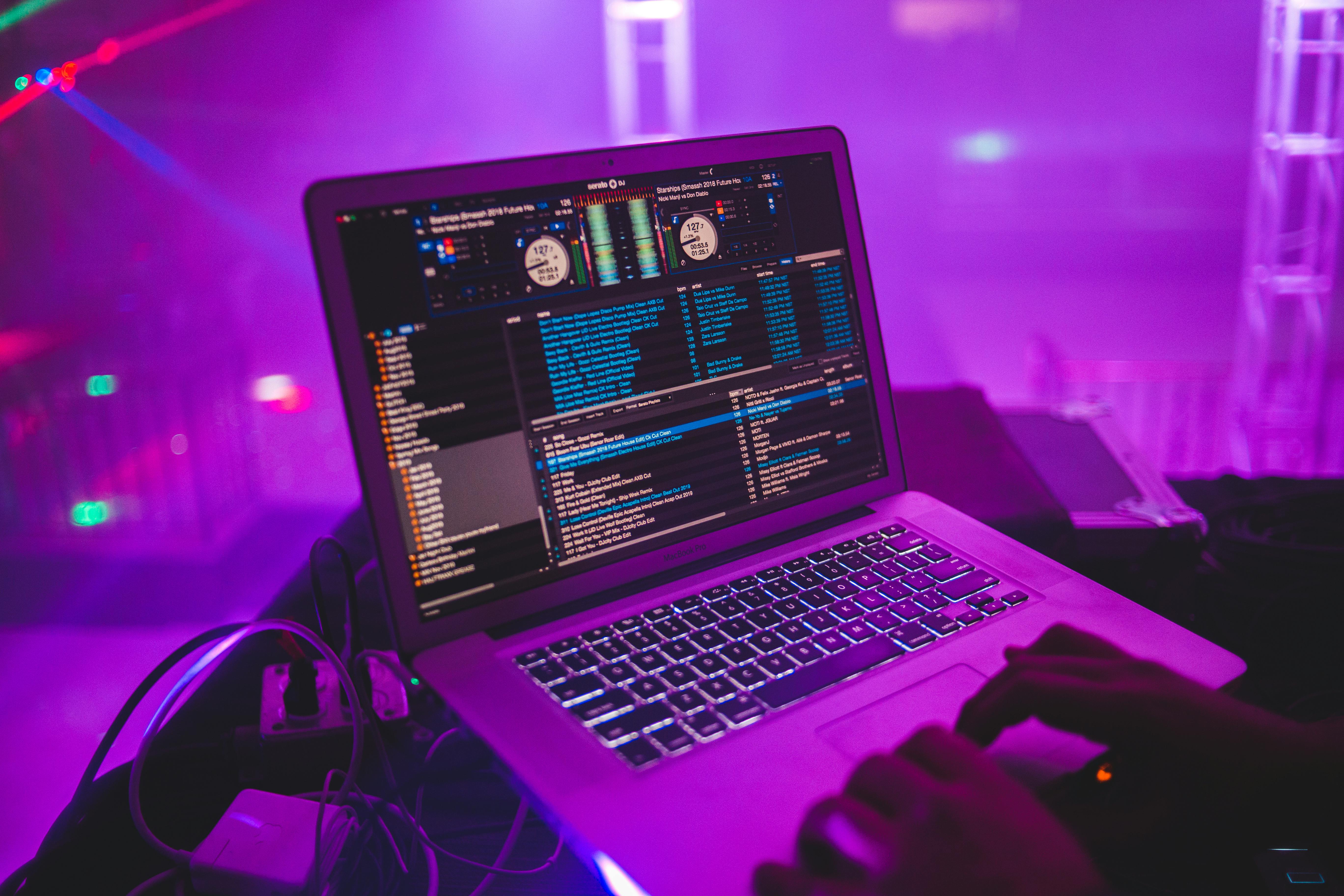 crop dj with laptop in club
