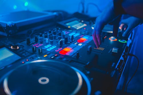 Free Person Playing Dj Mixer With Blue Lights Stock Photo