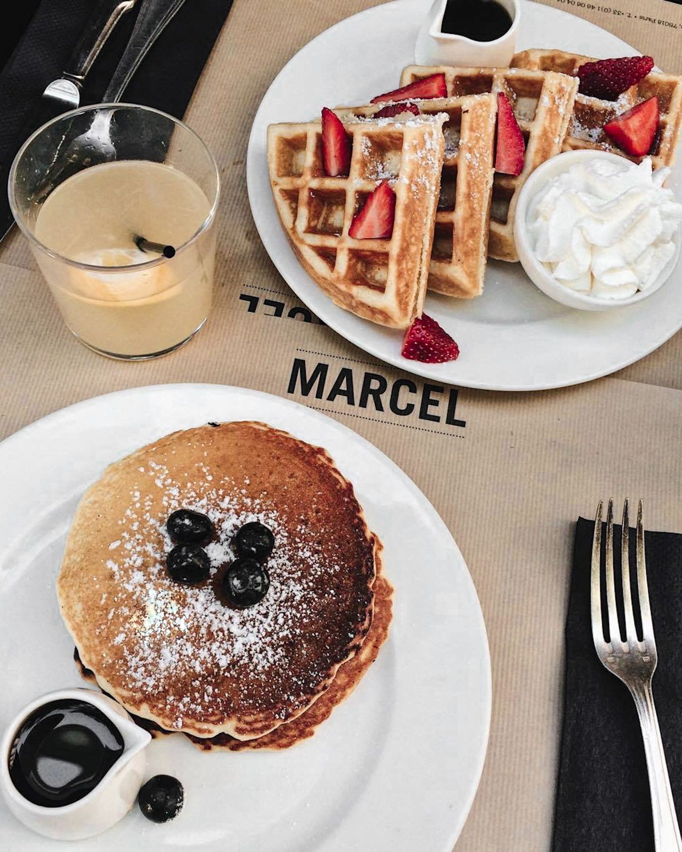 Waffles and pancakes served side by side with berries for a direct breakfast comparison