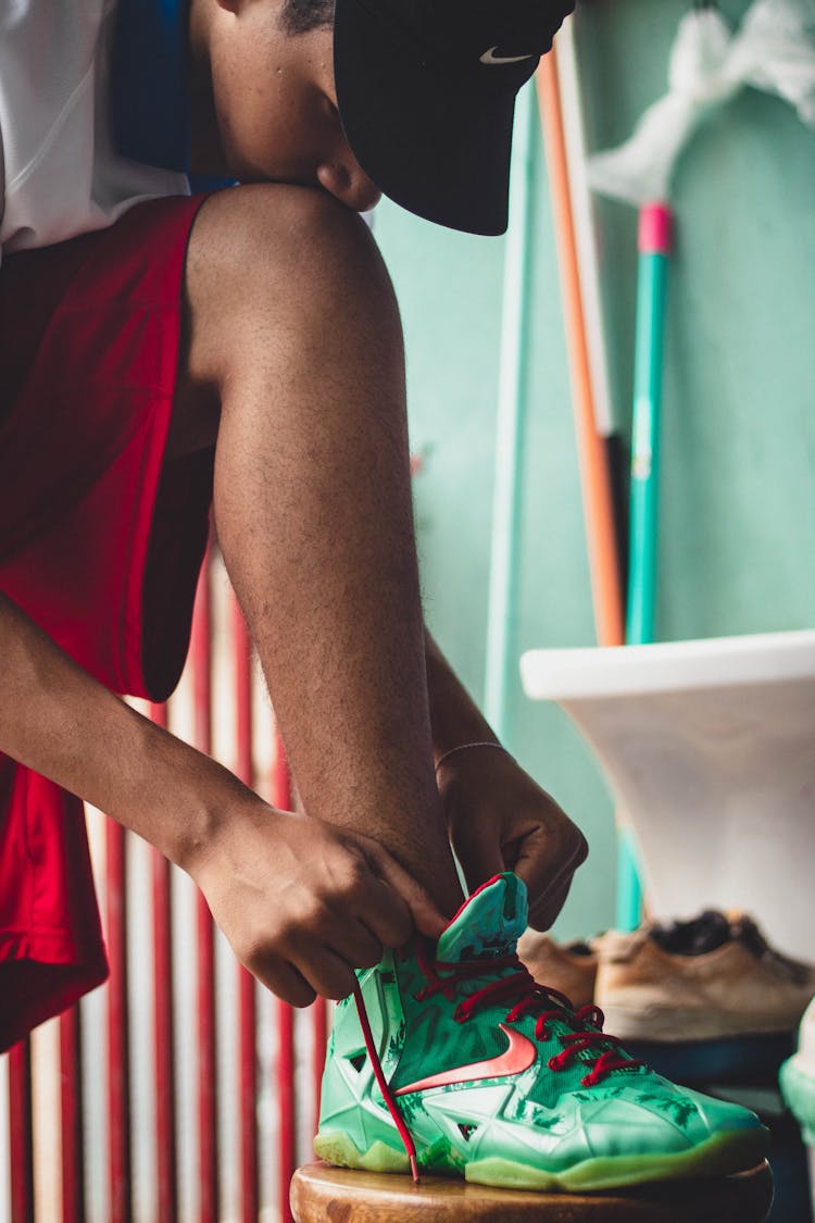 Photo Of A Man Tying His Shoelace