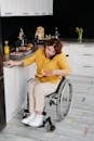 Woman in Yellow Long Sleeve Shirt Sitting on Wheelchair