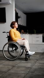 woman in a yellow shirt sitting in a wheelchair