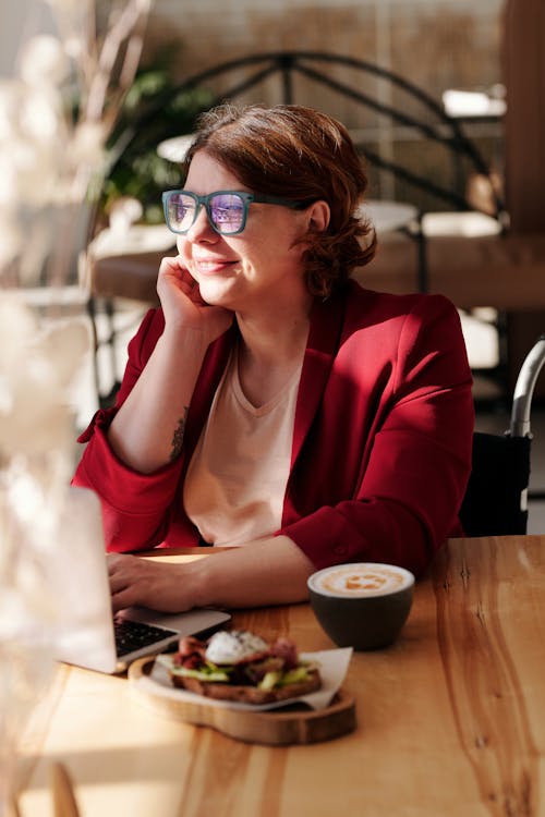 Woman in Red Blazer Wearing Green Framed Eyeglasses