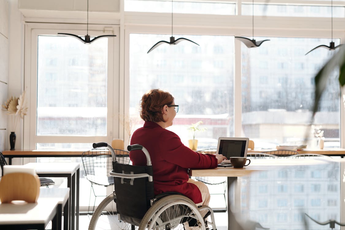 Free Woman in Red Blazer Sitting on Wheelchair Stock Photo