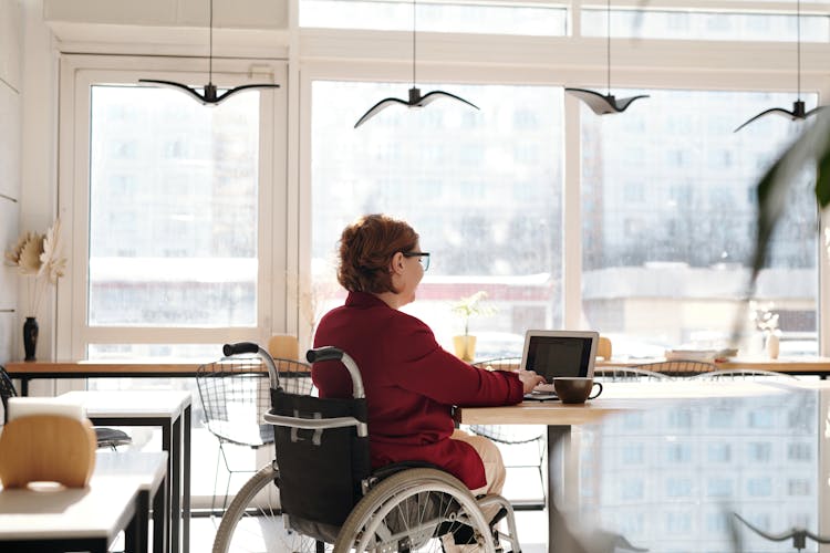 Woman In Red Blazer Sitting On Wheelchair