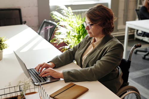 A Woman in Eyeglasses While using Laptop