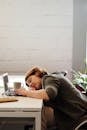 Photo of Woman Leaning on Her Desk