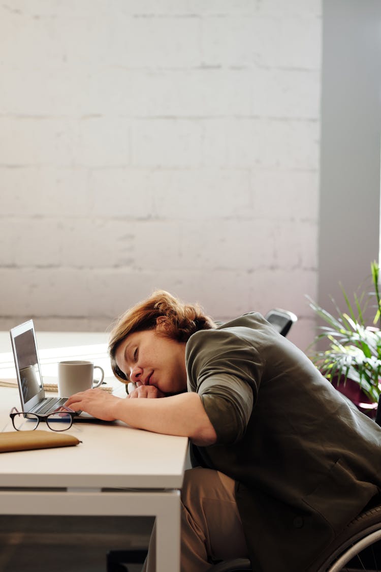 Photo Of Woman Leaning On Her Desk