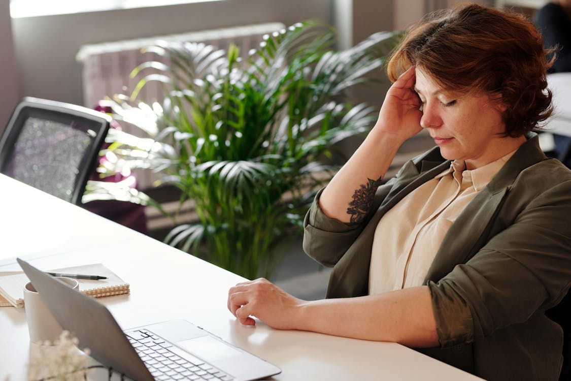 A person struggling to concentrate on work.