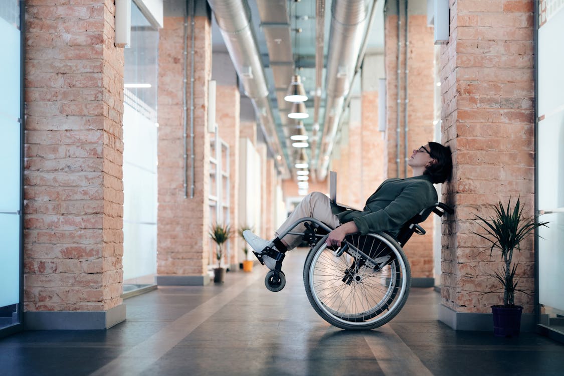 A woman in a wheelchair taking a break from work. 