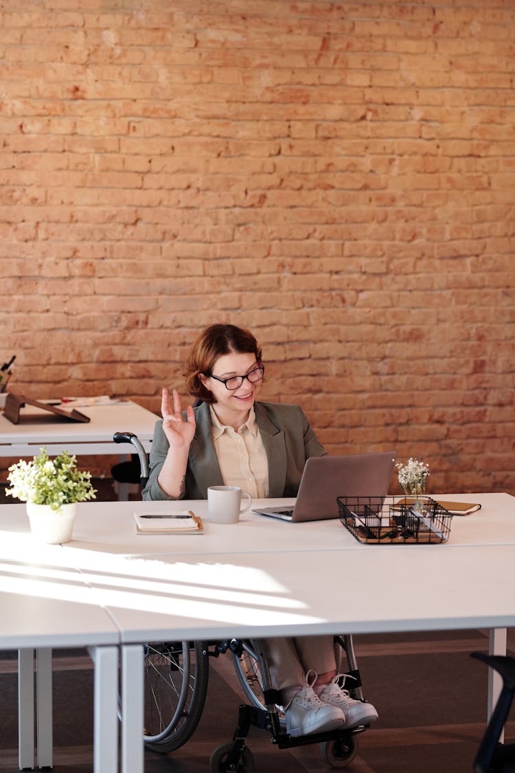 Woman Smiling While Using Laptop