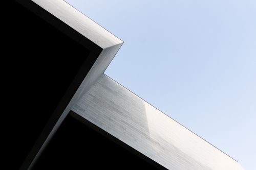 Free Minimalist view of a geometric building corner against a clear sky in Vilnius. Stock Photo