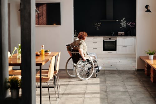 Free Photo of Woman on Wheelchair Going to the Kitchen Stock Photo