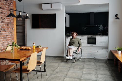 Free Woman Sitting on Wheelchair While Looking Away Stock Photo