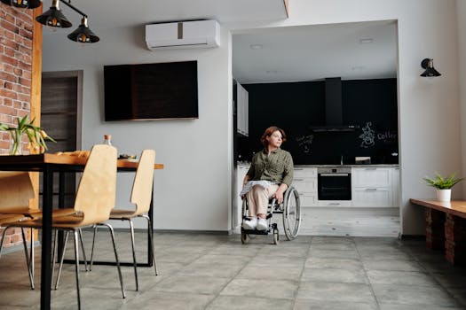 Woman in wheelchair in a modern kitchen setting, deeply contemplating life. Indoor scene highlighting accessibility and inclusion.