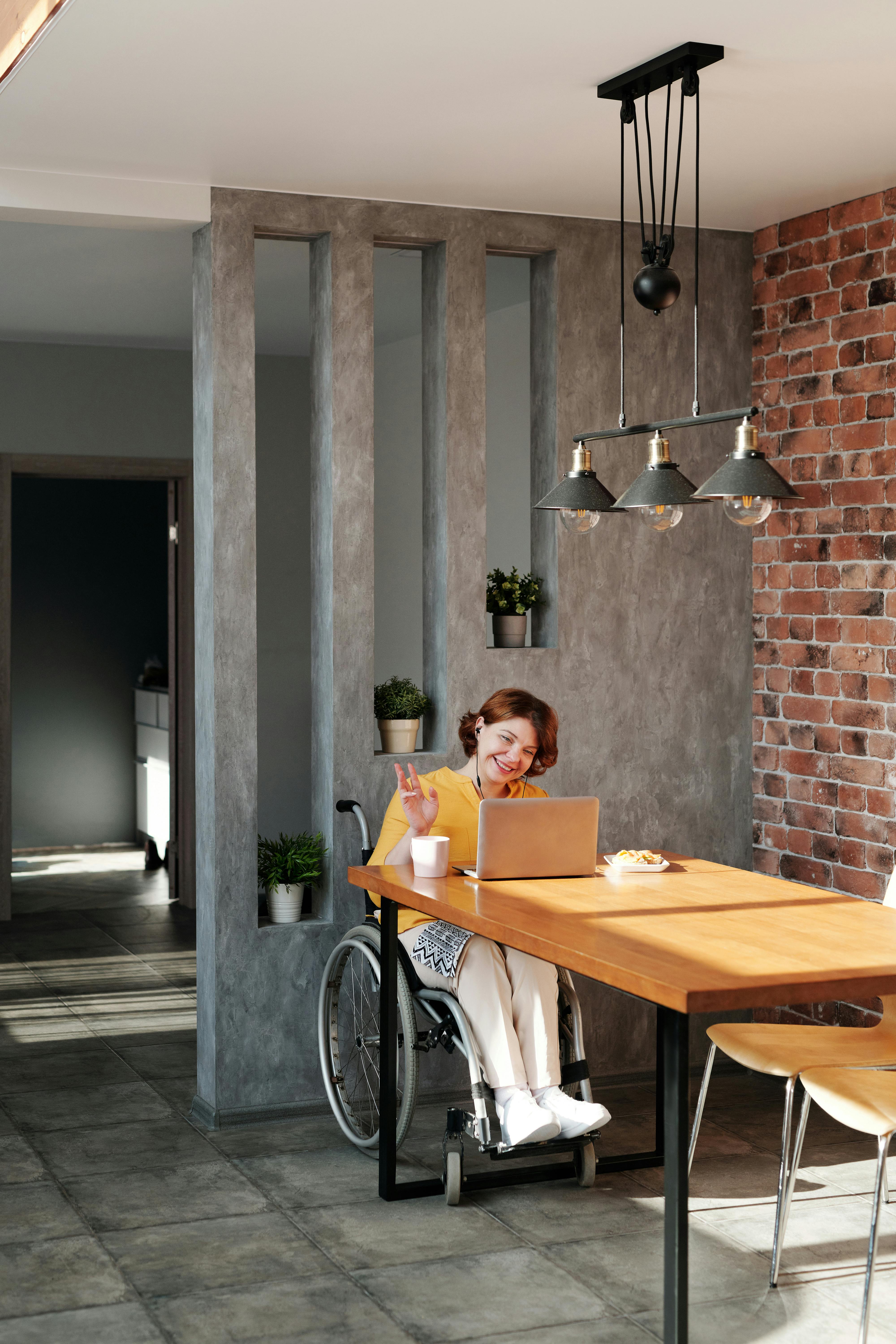 photo of woman smiling while using laptop