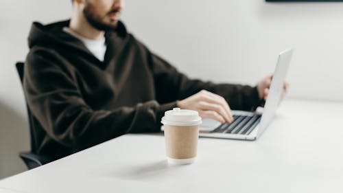 Man in Black Sweater Using Macbook Pro