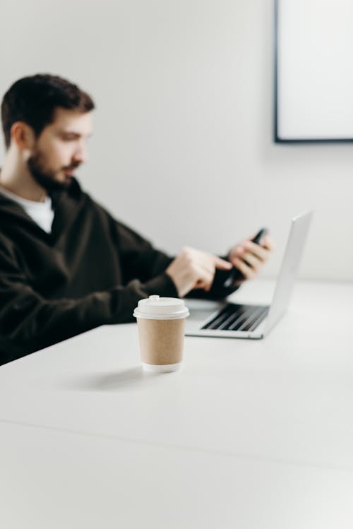 Man in Black Jacket Using Macbook Pro