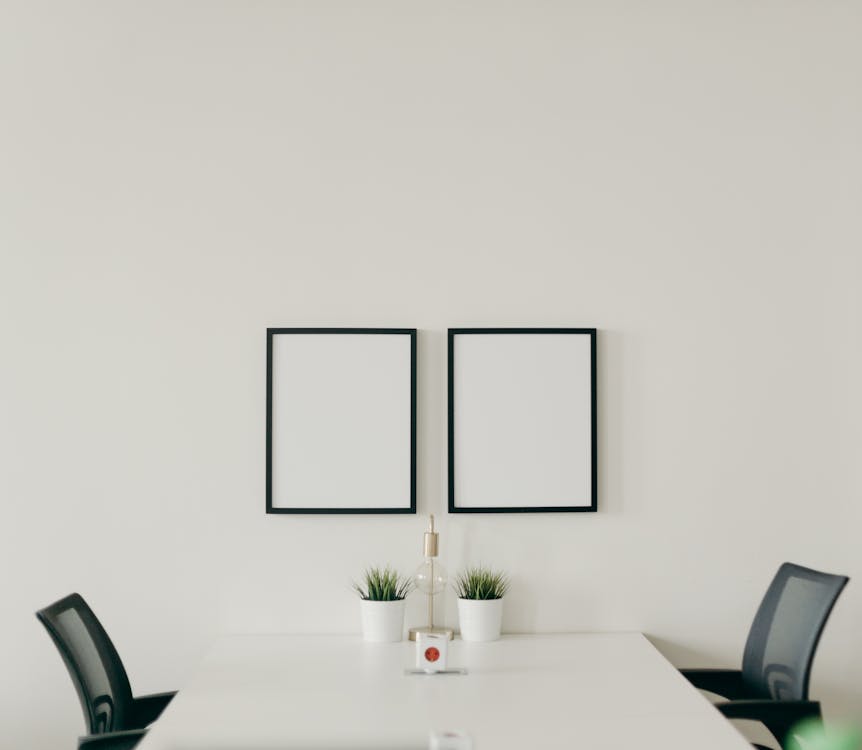 White Wooden Table With Chairs In A Room