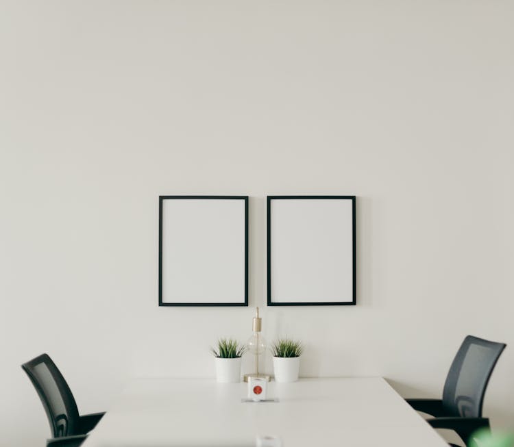 White Wooden Table With Chairs In A Room