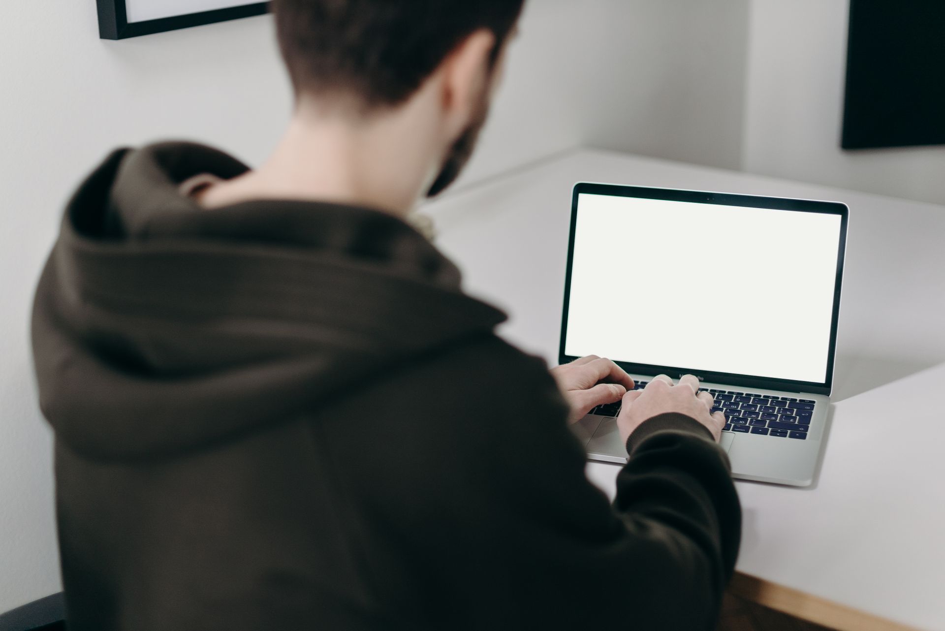 Man in Black Long Sleeve Shirt Using Macbook Pro