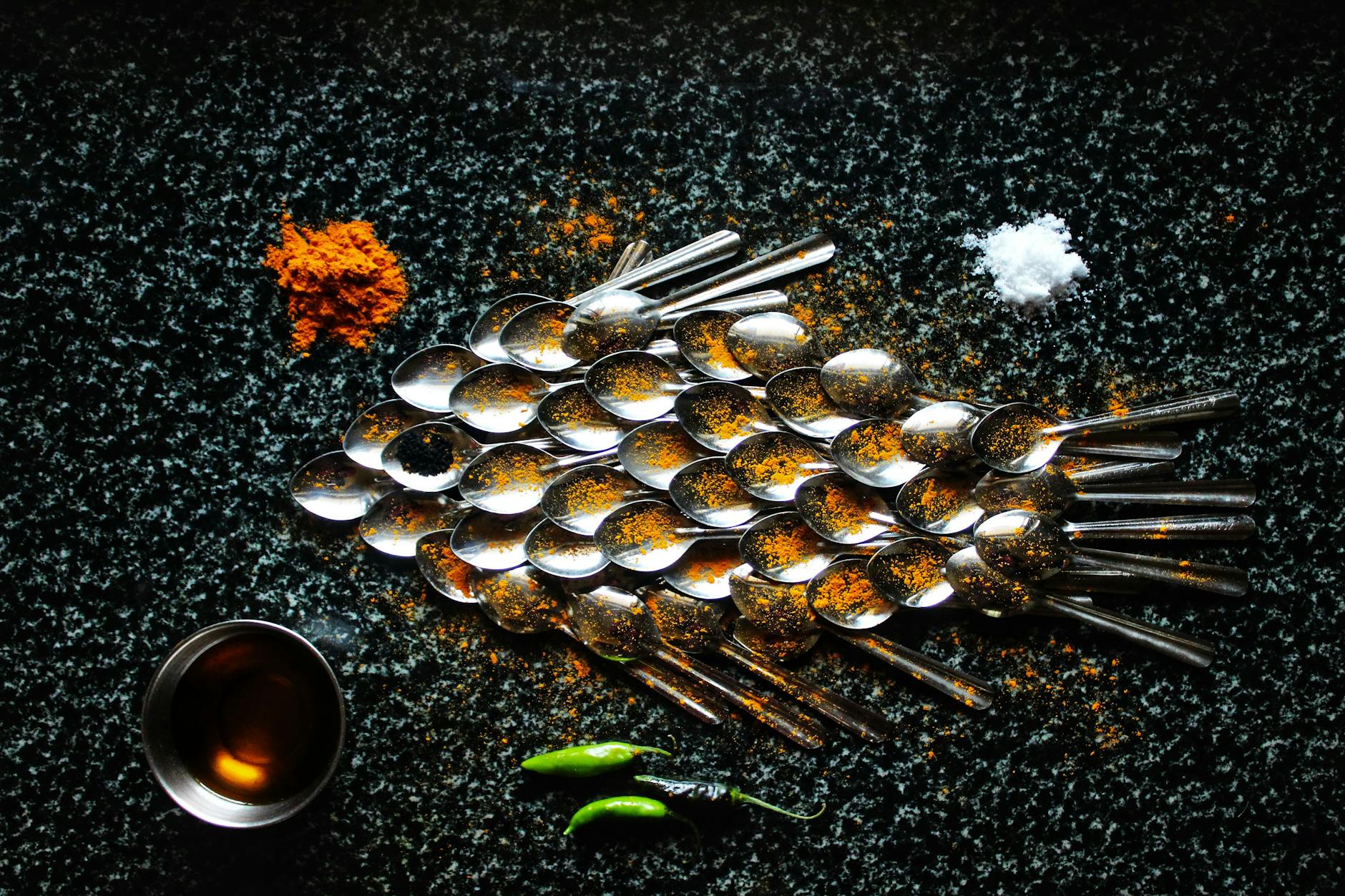 Steel spoons and spices in creative serving