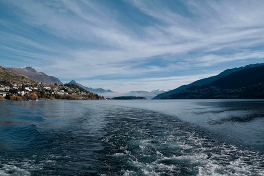 Serene view of Lake Wakatipu and surrounding mountains in Queenstown, New Zealand.