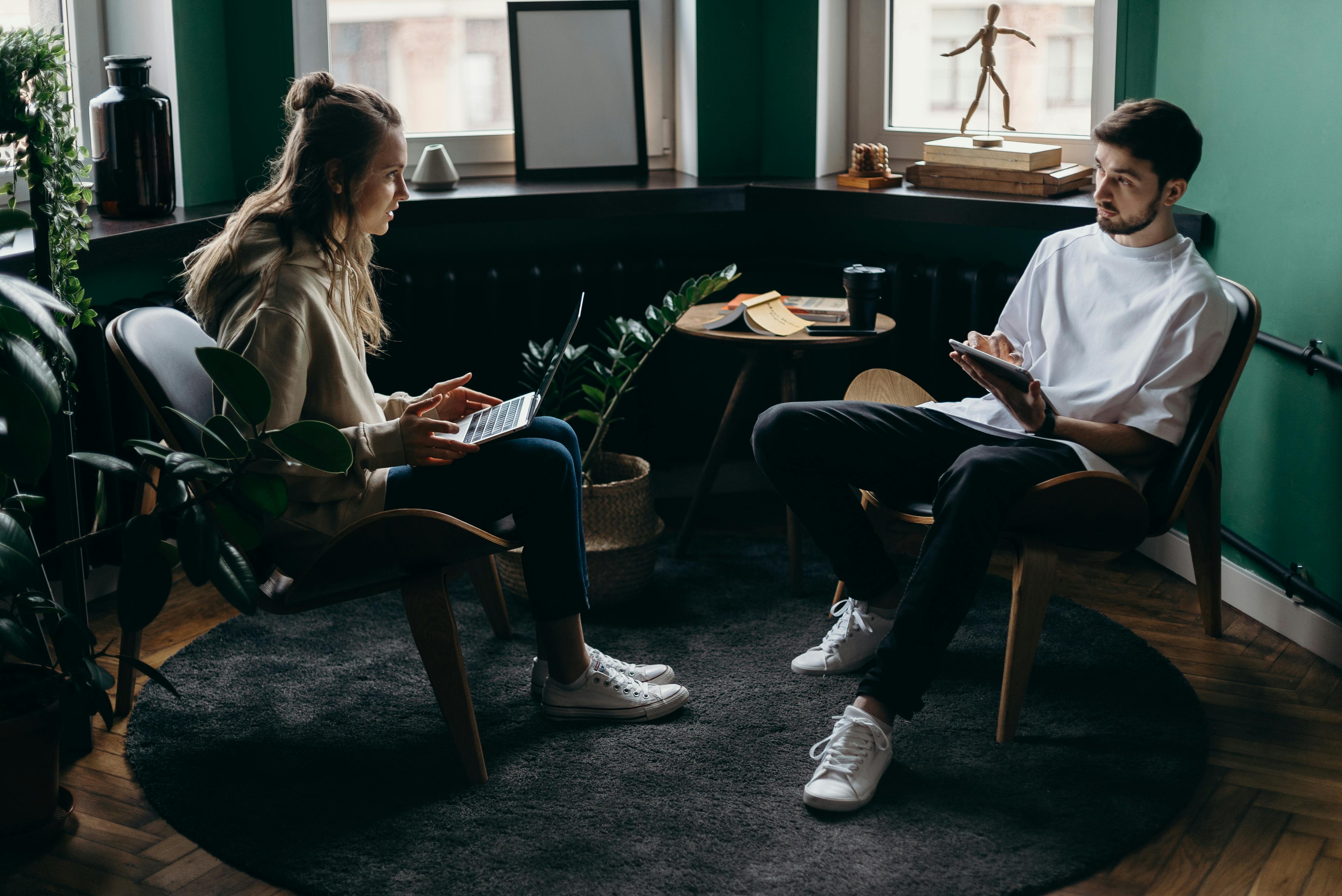 photo of man and woman talking to each other